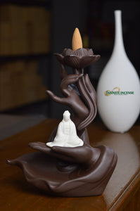 Buddha sitting on meditating hands with lotus flower